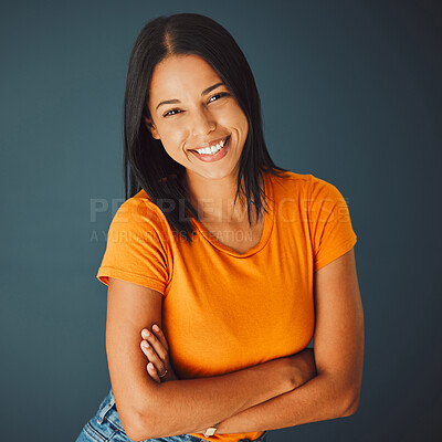 Buy stock photo Portrait, fashion and arms crossed with a woman in studio on a gray background for confidence or positive attitude. Happy, smile and confident with an attractive young female posing indoor for style