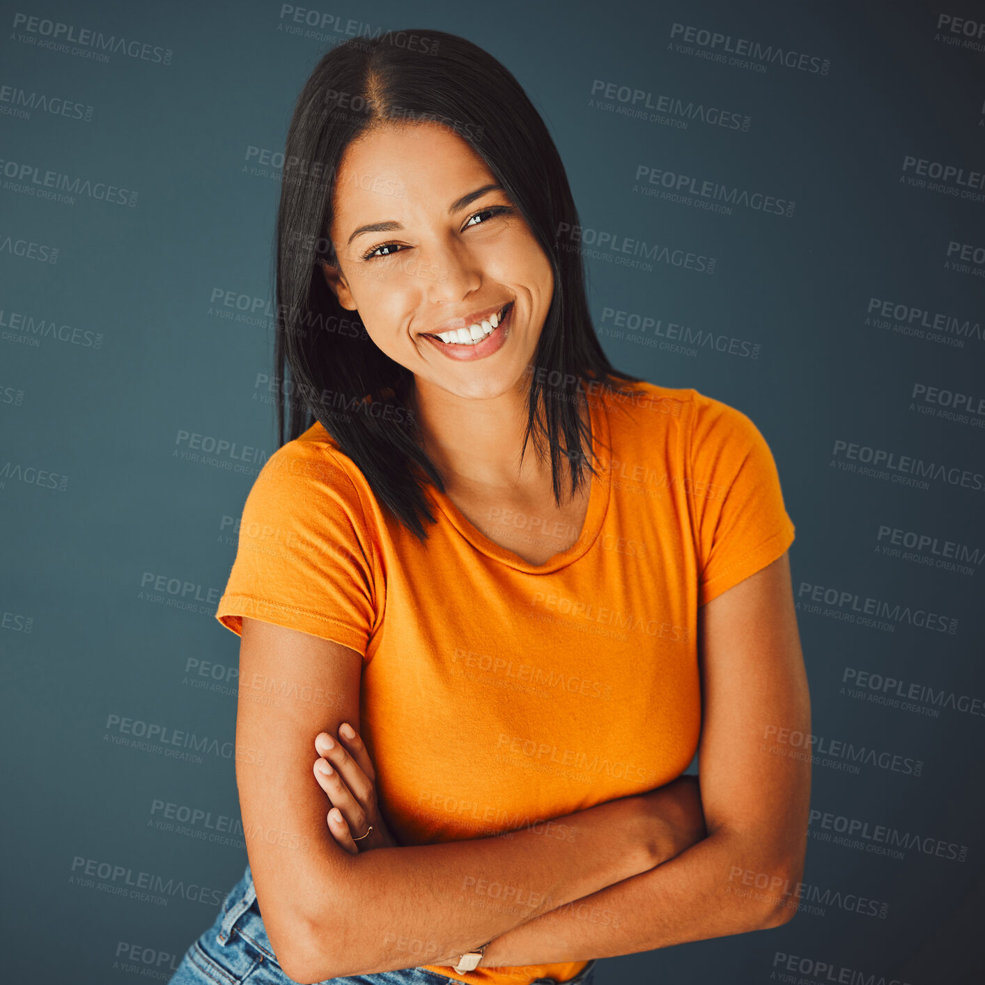 Buy stock photo Portrait, fashion and arms crossed with a woman in studio on a gray background for confidence or positive attitude. Happy, smile and confident with an attractive young female posing indoor for style