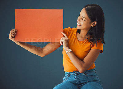 Buy stock photo Woman, poster and mockup banner space for sale, discount or promotion. Happy model with advertising for product placement, logo or branding on billboard orange paper sign in studio background
