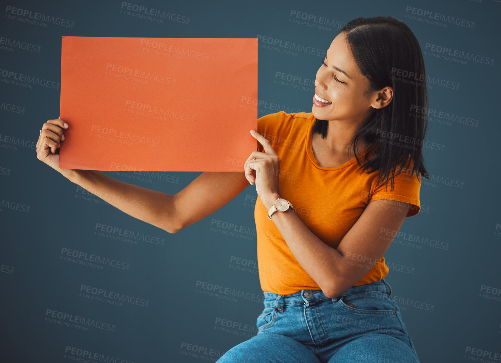 Buy stock photo Woman, poster and mockup banner space for sale, discount or promotion. Happy model with advertising for product placement, logo or branding on billboard orange paper sign in studio background
