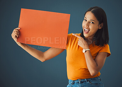 Buy stock photo Woman, poster portrait and wow mockup space for sale, discount or promotion. Model pointing or advertising product placement, logo or brand billboard on paper sign or banner in studio background
