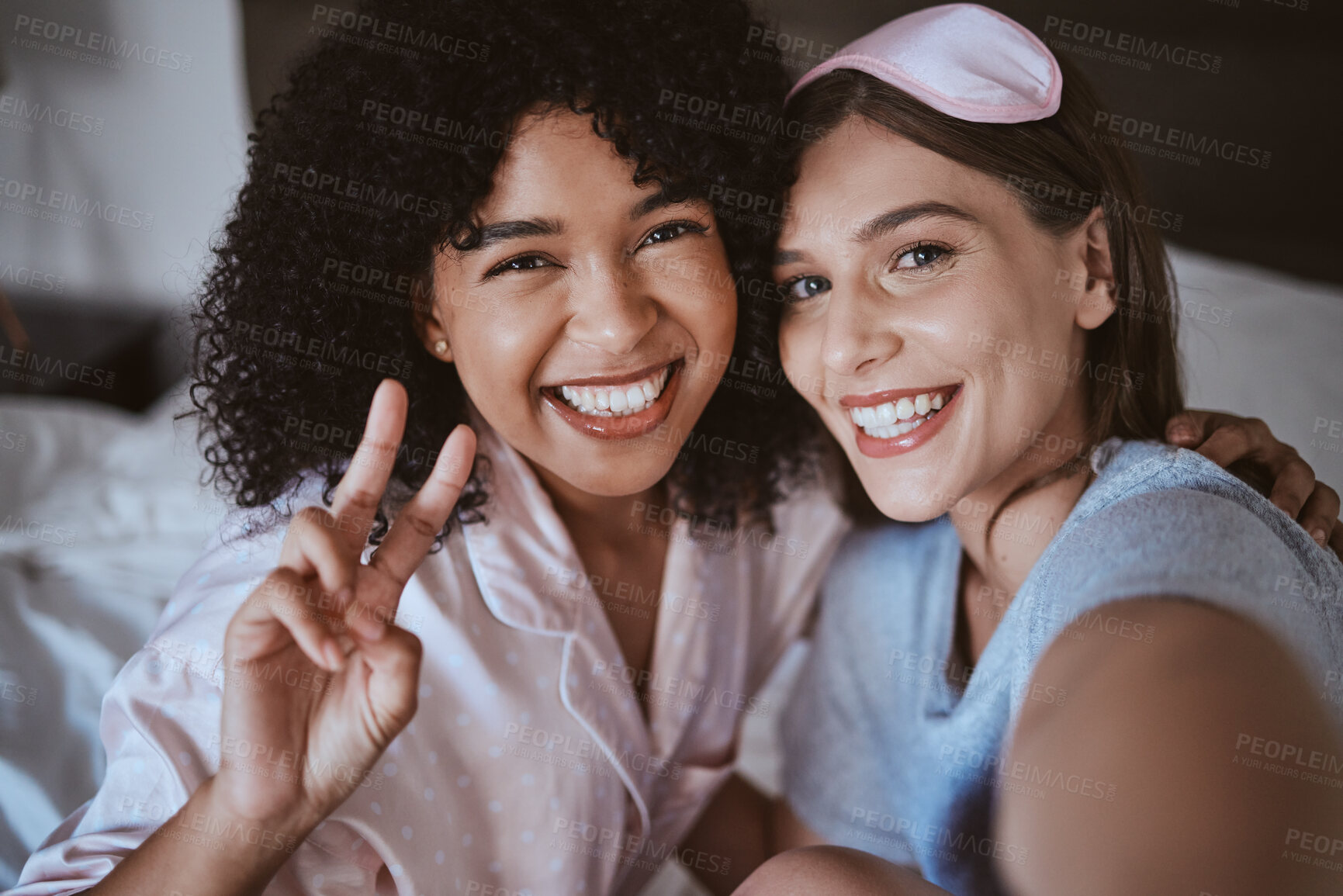 Buy stock photo Friends, selfie and smile, women on bed in pajamas with bonding, peace sign and happy face. Social media, girl and influencer in portrait picture, sharing memory and friendship at bedroom sleepover.