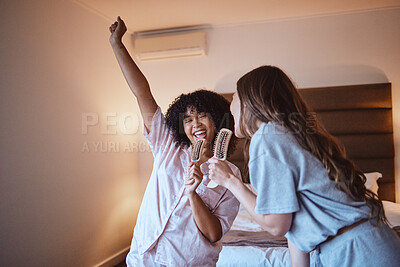 Buy stock photo Women, karaoke and singing in bedroom with brush and pjs, friends get ready for crazy girls night out, music concert and happiness. Girl, friend and happy smile, girlfriends at sleepover in pajamas.
