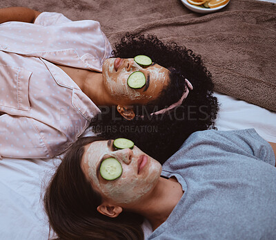 Buy stock photo Facial, cucumber and sleepover with girl best friends lying on the floor together for beauty treatment. Face mask, skincare or natural care with a female and friend at home to relax while bonding