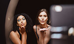 Beauty, fashion and woman friends blowing a kiss together while recording a vlog as an influencer team. Social media, makeup and affection with a female and friend live streaming a broadcast