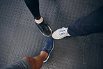Group fitness, feet and shoes of people together at gym for exercise, training and a workout together. Above sneakers of men at gym for health and wellness with motivation, teamwork and sports