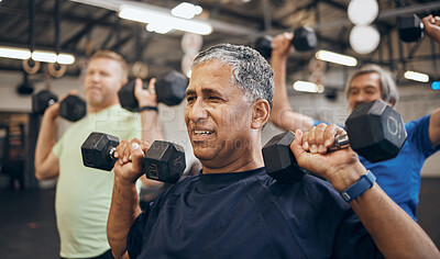Training, group and senior men exercise together at the gym lifting weights with dumbbells equipment for strength. Elderly, old and fitness people workout in a health club for wellness and health