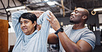 Coach, personal trainer and senior woman stretching arms in gym with black man for flexibility. Physiotherapy, training and elderly female with trainer helping with workout and exercise for health.