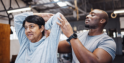 Buy stock photo Coach, personal trainer and senior woman stretching arms in gym with black man for flexibility. Physiotherapy, training and elderly female with trainer helping with workout and exercise for health.