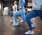 Stretching, fitness and women doing lunges in the gym for health, team yoga and workout in a class. Legs, exercise and group of people at a club for body training, balance and cardio together