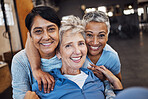 Mature women, portrait and hug in gym, workout or training healthcare wellness, bonding activity or exercise class. Smile, happy and retirement fitness friends in diversity group or community support