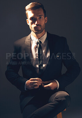 Buy stock photo Businessman, suit and portrait in dark studio for corporate fashion, design or professional aesthetic. Young executive leader, model and focus for vision, entrepreneur mindset or tattoo by background