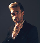 Portrait, fashion and man in formal suit, trendy and elegant with confident guy on dark studio background. Face, male and entrepreneur with fancy outfit, trendy clothes and executive with aesthetic