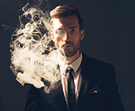 Executive, portrait and man with smoke in a suit for fashion isolated on a dark background in studio. Sexy, vintage and businessman looking stylish, professional and rich while smoking on a backdrop