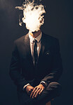 Businessman, suit and smoke in dark studio for corporate fashion, design or professional aesthetic. Young executive leader, model and focus for vision, entrepreneur mindset or tattoo by background