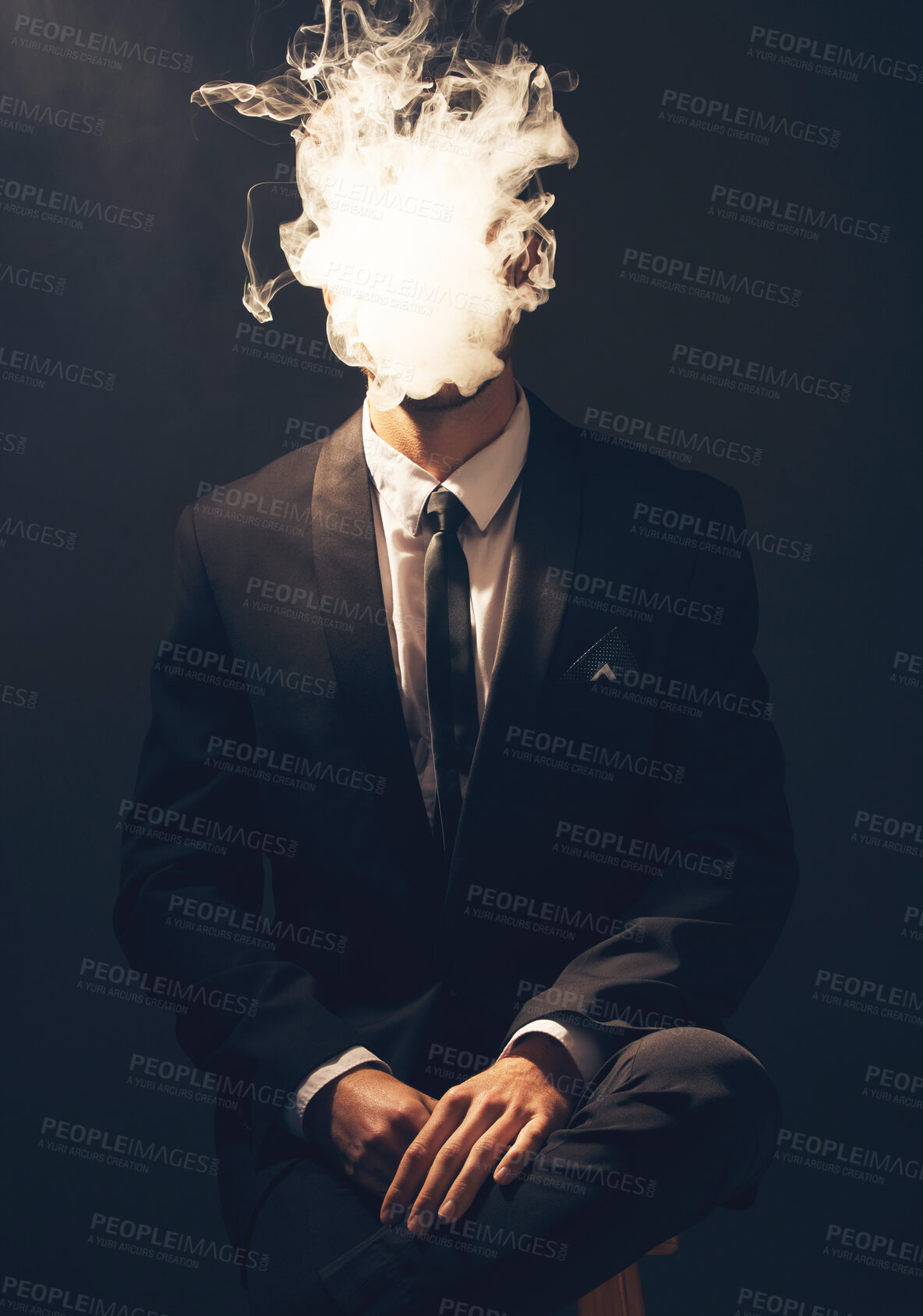 Buy stock photo Businessman, suit and smoke in dark studio for corporate fashion, mafia aesthetic and success. Young model, man and smoking to hide face in secret for crime boss, vintage hand by black background