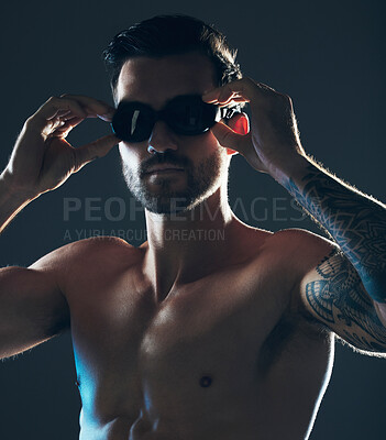 Buy stock photo Fitness, sports and face of swimmer with goggles isolated in studio for wellness, exercise and training. Workout, swimming athlete and man focus on dark background with muscle, strong body and tattoo