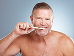 Portrait, cleaning or old man brushing teeth with dental toothpaste for healthy oral hygiene grooming in studio. Eco friendly, beauty or senior person with a natural bamboo wood toothbrush for care
