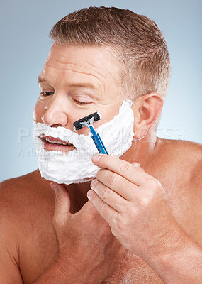 Buy stock photo Face, shaving cream and man with razor in studio isolated on a gray background for hair removal. Cleaning, skincare and senior male model with facial foam to shave for aesthetics, health or wellness.