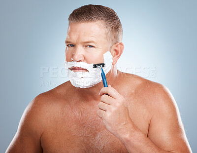 Buy stock photo Portrait, shaving cream and man with razor in studio isolated on a blue background for hair removal. Face, skincare and  mature male model with facial foam to shave for aesthetics, health or wellness