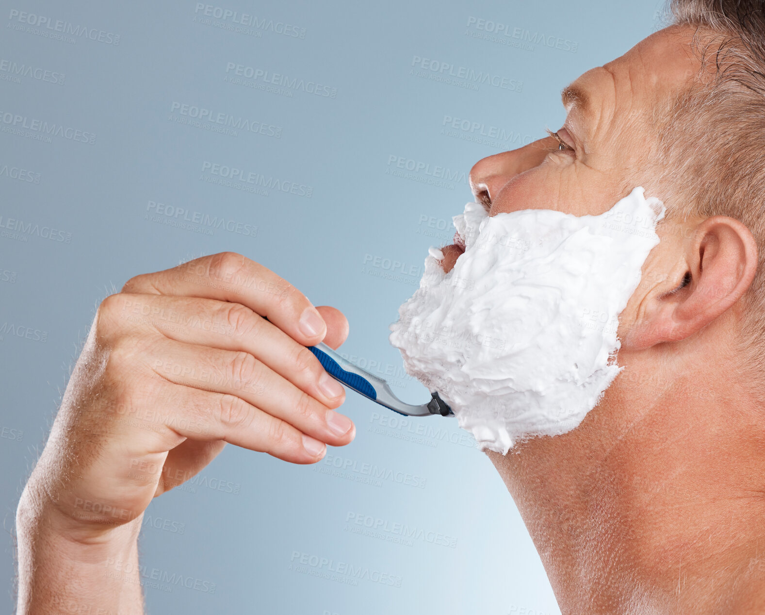Buy stock photo Razor, face and man with shaving cream in studio isolated on a gray background for hair removal. Profile, skincare and senior male model with facial foam to shave for aesthetics, health or wellness.