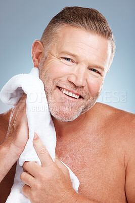 Buy stock photo Man, portrait smile and towel for grooming, skincare or clean shave in hygiene against gray studio background. Happy male smiling with teeth in satisfaction for self love or care for facial treatment