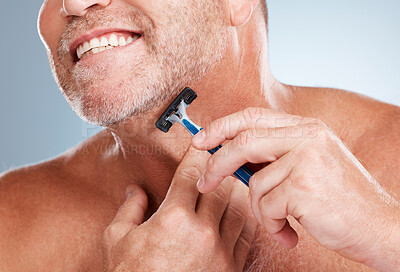Buy stock photo Epilation, razor and man shaving his face in a studio for a facial, skincare and hygiene routine. Health, wellness and mature male doing face hair removal treatment with a shaver by gray background.