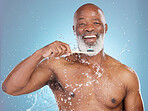 Portrait, black man and toothbrush with water, brushing teeth or oral health with guy on blue studio background. African American male, senior citizen or toothpaste for dental hygiene or fresh breath