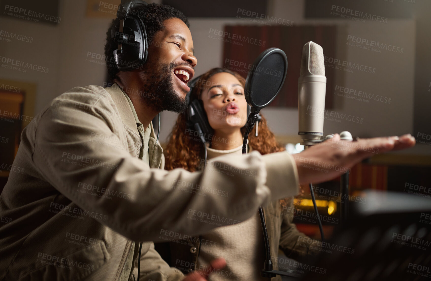 Buy stock photo Music, man and woman recording in studio in home, singing into microphone with headphones and talent. Technology, art and creative influencer band or musician with live stream song for record label.