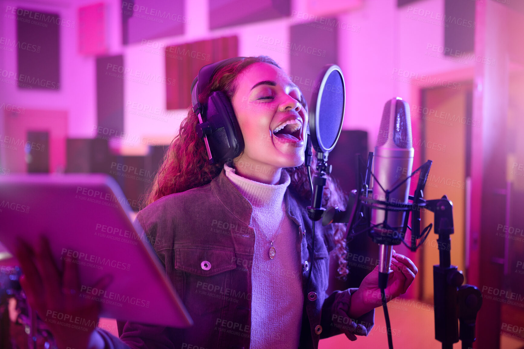 Buy stock photo Technology, singing or woman on neon microphone, music studio lyrics or songwriting app in night recording. Singer, musician or artist on tablet in production, voice media or sound light performance