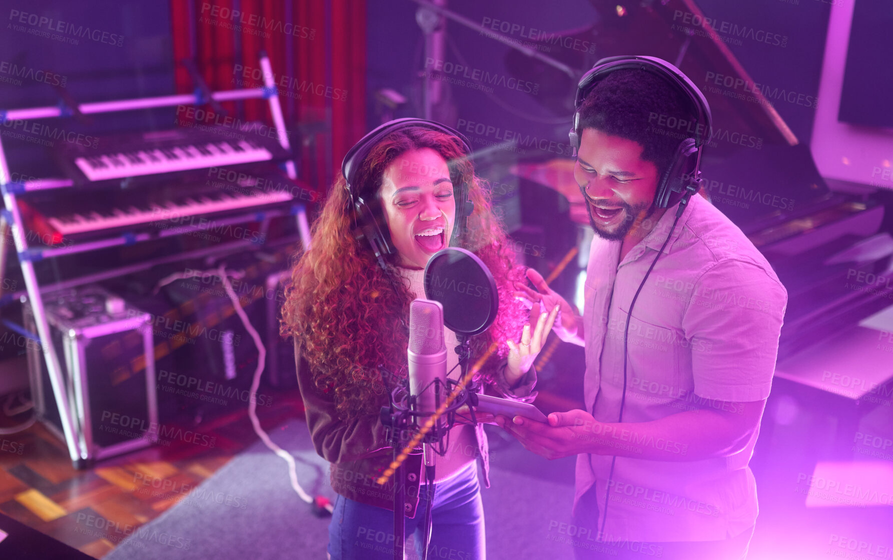 Buy stock photo Technology, singing or musician people on neon studio microphone or music lyrics app in night recording. Singers, collaboration or artists on tablet production, voice media or light sound performance