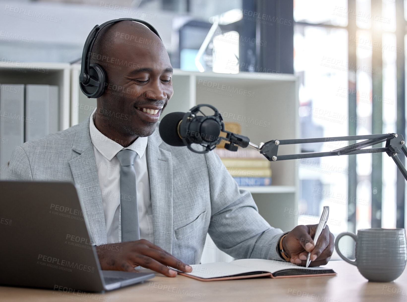 Buy stock photo Radio host, black man and networking with laptop, smile and writing for interview, speaking and business influencer. Presenter, African male and speaker with notebook, microphone and audio broadcast