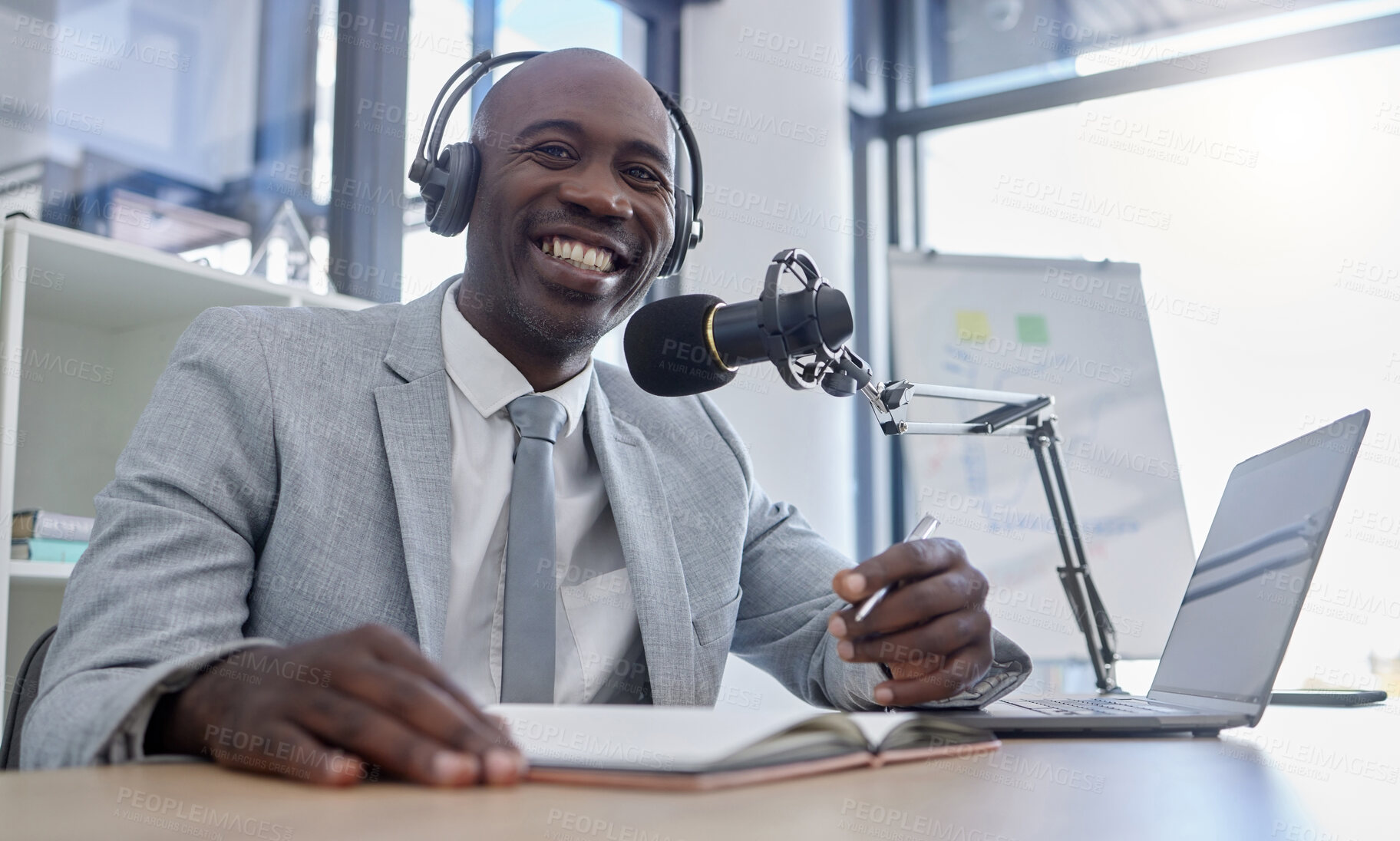 Buy stock photo Portrait, microphone and man on laptop for radio, podcast or business influencer in studio, happy and excited. Face, talk show and host by black guy streaming creative, finance and  live audience