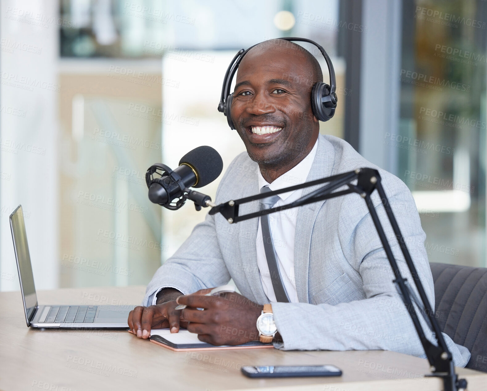 Buy stock photo Portrait, laptop and news with a black man radio presenter writing in a notebook during a live broadcast. Computer, podcast and microphone with a male journalist working in media for a talk show