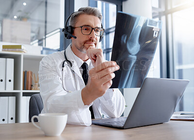 Buy stock photo Doctor, x ray and man with headset and laptop in hospital for healthcare or online consultation. Thinking, radiology telehealth and mature medical physician looking at mammogram picture or bone xray.
