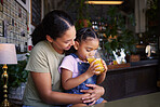 Coffee shop, black family and hug with a mother and daughter enjoying a beverage in a cafe together. Hugging, caffeine and love with a young woman and happy female child bonding in a restaurant