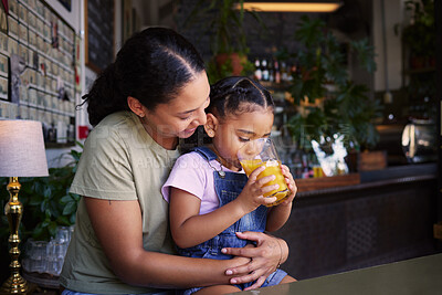 Buy stock photo Coffee shop, black family and hug with a mother and daughter enjoying a beverage in a cafe together. Hugging, caffeine and love with a young woman and happy female child bonding in a restaurant