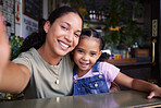 Cafe, black family and selfie with a mother and daughter enjoying spending time together in a coffee shop. Portrait, kids and smile with a woman and happy female child bonding in a restaurant