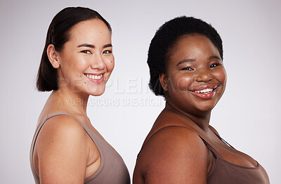 Buy stock photo Portrait, black woman and Asian girl with skincare, friends and smile with confidence, cosmetics and body care on grey studio background. Face, diversity and females with happiness and dermatology