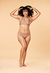 Hair care, tongue out and beauty of black woman in lingerie in studio isolated on a brown background. Underwear, skincare and cosmetics of happy young model with spa treatment for growth and texture.