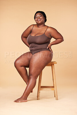 Naked lady in black underwear poses on a chair Stock Photo by
