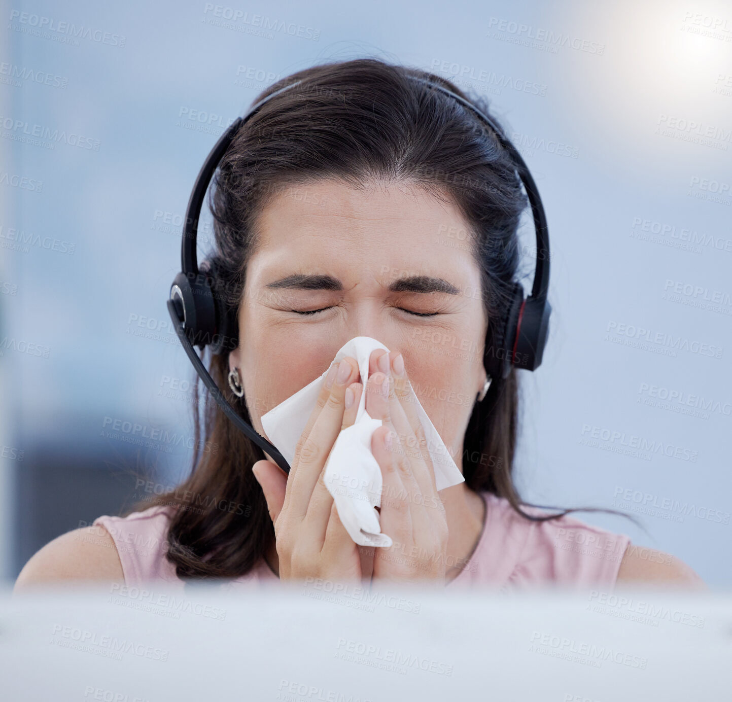 Buy stock photo Customer service, covid and blowing nose with a woman consultant working in a call center while sick. CRM, telemarketing and cold or flu with a female sneezing while consulting using a headset