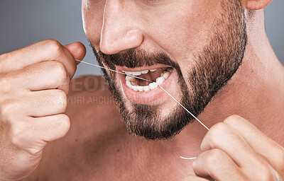 Buy stock photo Mouth floss, tooth and man in studio for beauty, healthy body care and hygiene on background. Closeup of male, teeth flossing and cleaning face for facial wellness, fresh breath and dental cosmetics