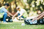 Volunteer hands, plastic and pollution while cleaning park for community service for environment and recycling. People  group helping with bottle and trash bag outdoor on grass for ngo clean project