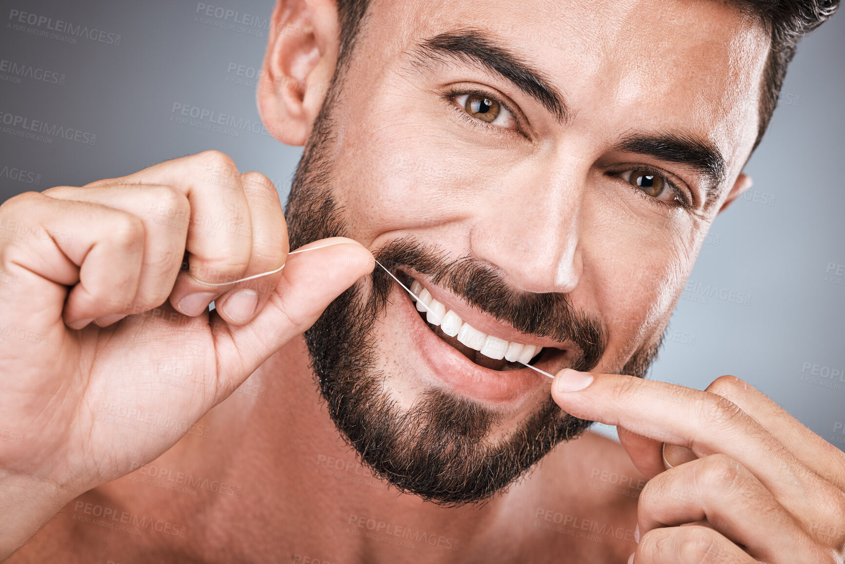 Buy stock photo Floss, cleaning teeth and portrait of man in studio for beauty, healthy body and hygiene on background. Male model, tooth flossing and mouth for facial smile, fresh breath and happy dental wellness