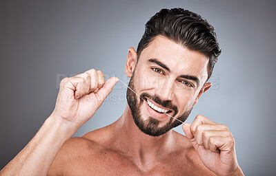 Buy stock photo Floss, dental wellness and portrait of man in studio for beauty, healthy body and hygiene on background. Male model, tooth flossing and cleaning mouth for facial smile, fresh breath and happy teeth