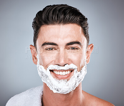 Buy stock photo Grooming, shaving and portrait of a man with cream on face isolated on a grey studio background. Happy, hygiene and headshot of a person with a facial product for beard hair removal on a backdrop