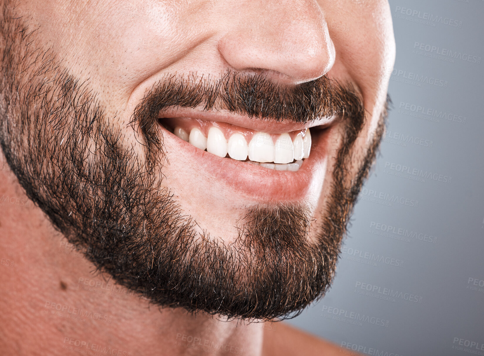 Buy stock photo Smile, dental health and mouth of a man with teeth isolated on grey studio background. Happy, showing and beard of a model with results from tooth whitening, dentist cleaning and hygiene on backdrop