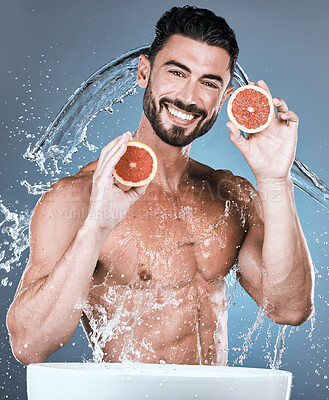 Buy stock photo Portrait, water splash and man with grapefruit in studio isolated on a blue background. Skincare, vegan fruits and happy male model washing or cleaning food for hygiene, healthy diet and vitamin c.