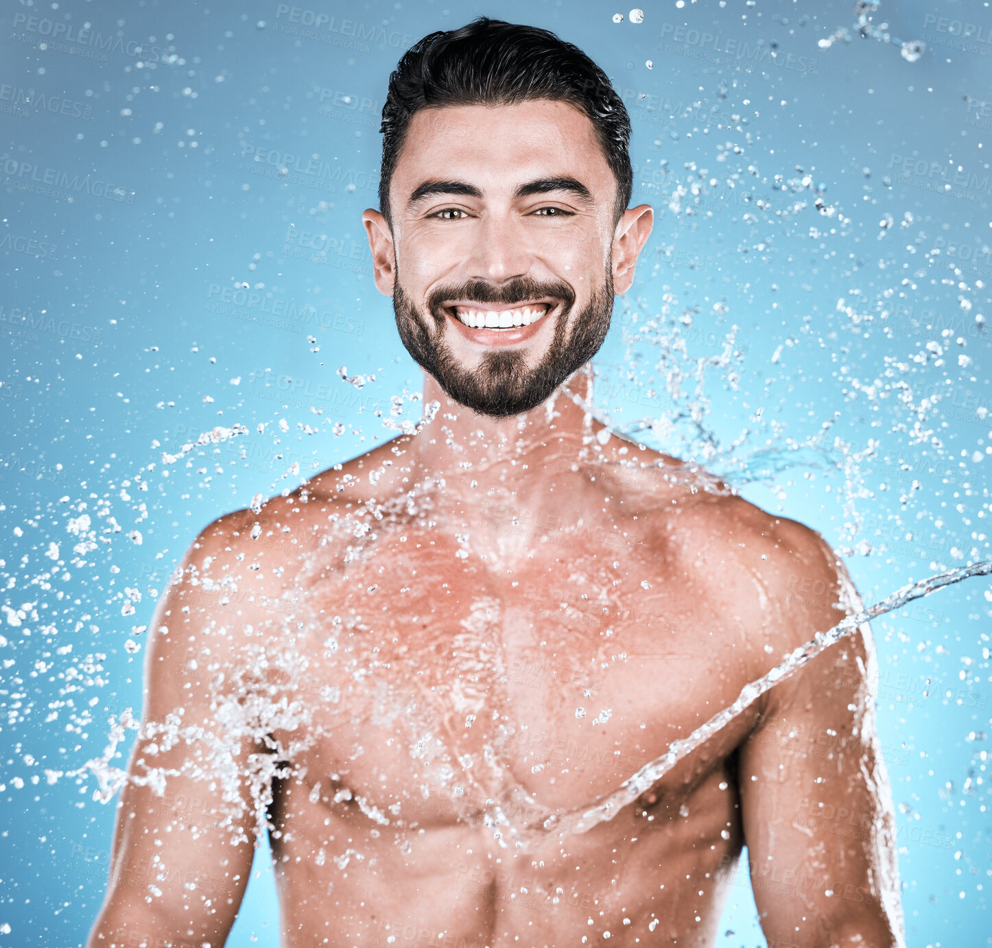 Buy stock photo Water drops, hygiene and shower with man in portrait for beauty and skincare isolated on blue background. Smile, face and cleaning body with muscle, sustainability and happy with natural cosmetics